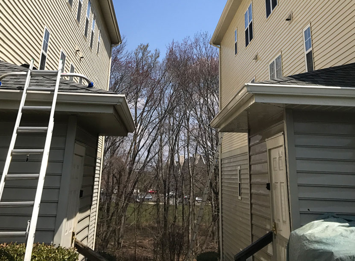 Commercial building in a damp area with exterior siding showing moisture, dirt, and mildew before professional pressure washing and cleaning.