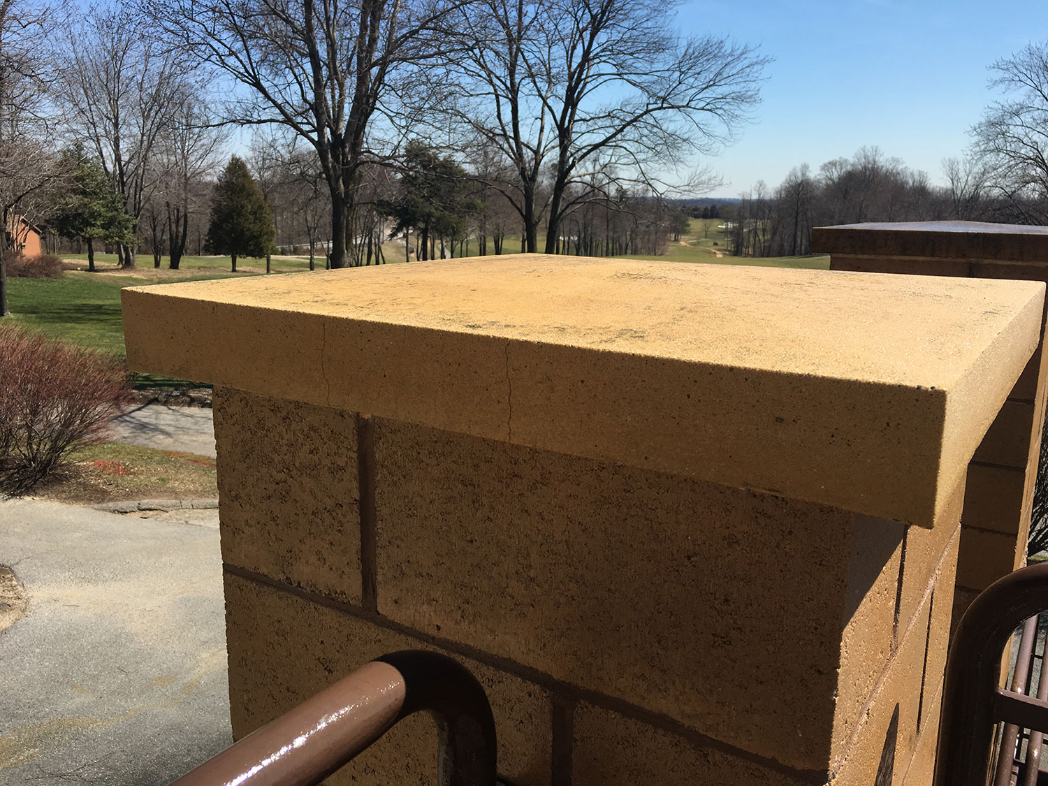Stone column after professional pressure washing restores its clean, natural appearance.