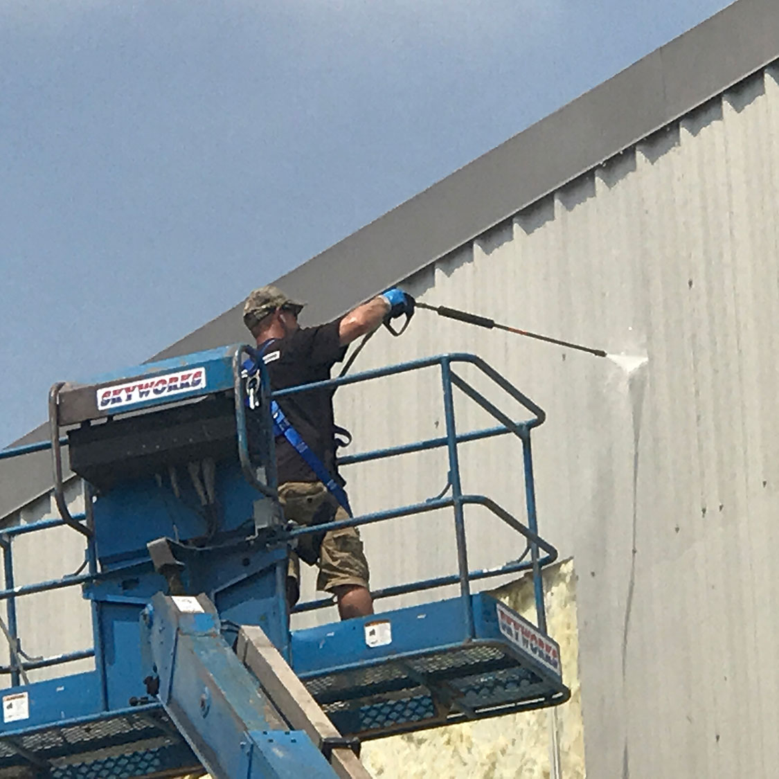 Under Pressure power washing a commercial building